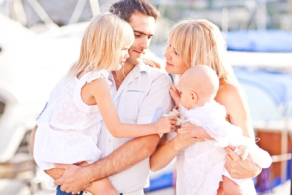 Happy family having fun walking on the mooring near yachts — Stock Photo, Image