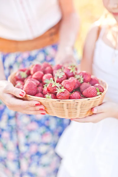Small child hand with basket of strawberry. Summer mood — Stock Photo, Image
