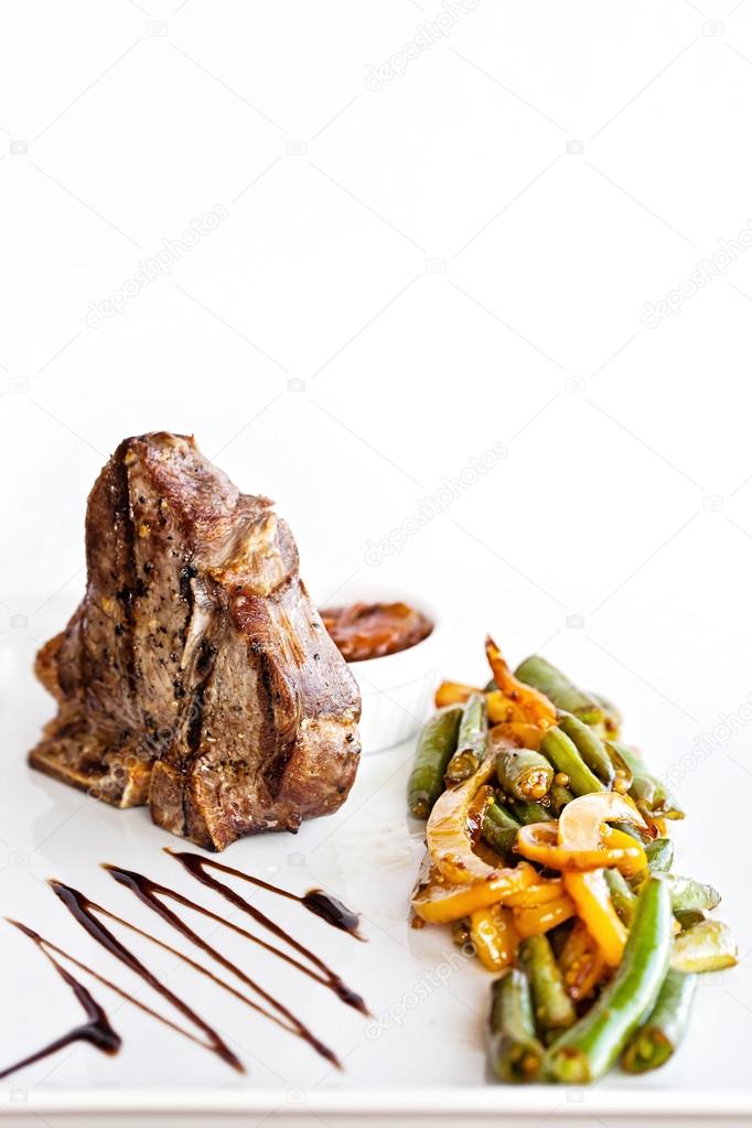 Club Beef steak with pepper sauce and Grilled vegetables on white plate