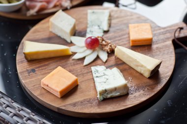 Şarap meze kümesi: et ve peynir seçimi, üzüm ve koyu ahşap arka plan üzerinde bir rustik ahşap tahta üzerinde ekmek. Üstten Görünüm, kopya alanı