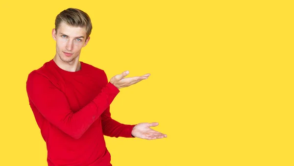 Young Man European Appearance Yellow Background Two Open Palms Indicates — Stock Photo, Image