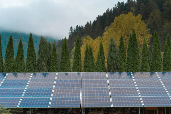 photovoltaic solar panels on mountains background, green clean alternative energy concept. copy space.