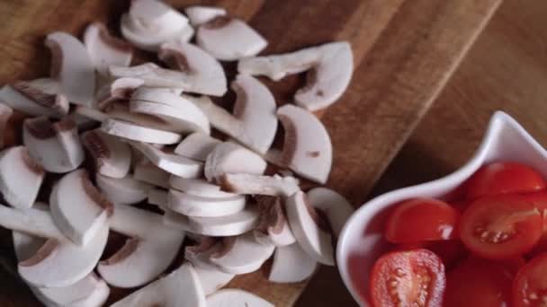 Ingredients for pizza pepper, tomatoes, cheese, mushrooms cut into pieces in plates on the table — Stock Video