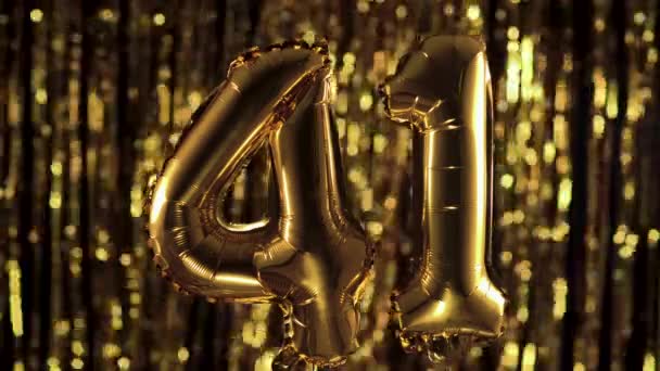 The golden number 41 forty one is made of an inflatable balloon on a yellow background. One of the complete set of numbers. Birthday, anniversary, date concept — Stock Video