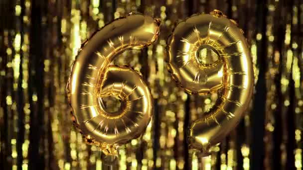 The golden number 69 sixty nine is made from an inflatable balloon on a yellow background. One of the complete set of numbers. Birthday, anniversary, date concept — Stock Video