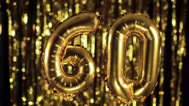 The golden number 60 sixty is made from an inflatable balloon on a yellow background. One of the complete set of numbers. Birthday, anniversary, date concept — Stock Video