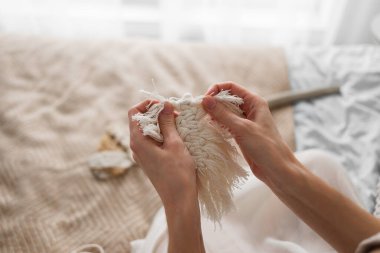 Dekor makromu. Bir kadının eli makrome tarzında bir Noel ağacını tutar. Boho dekor, eko dekorasyon, süsler, el yapımı, duvar halıları, makrome eğitimi, kopyalama alanı