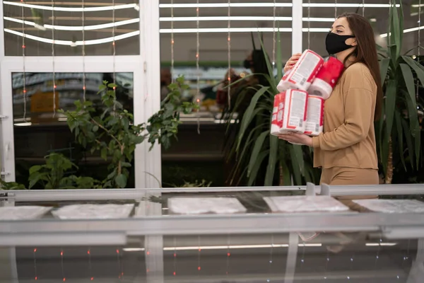 Women wearing glasses and wearing disposable medical mask shopping Toilet paper in supermarket