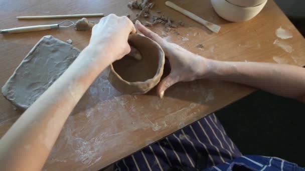 Una donna sconosciuta scolpisce argilla in ceramica. Il primo piano di mani di donne scolora un pezzo di argilla in un'officina. mani femminili che fanno un prodotto in studio. Processo di lavorazione ceramica. Senza volto.. — Video Stock