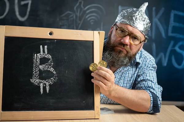 Bitcoin coins conspiracy theories in the hand of a conspiracy theorist sitting at a chalkboard table with a cryptocurrency sign. Currency artificial money drawing icon.