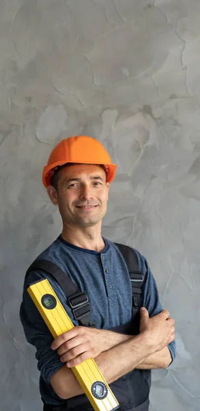 Builder Stands Building Level Protective Helmet Glasses Folded His Arms — Zdjęcie stockowe