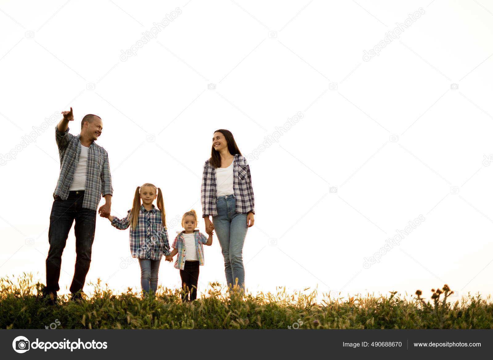 Portrait Of Happy Family Walking Over White Background Against