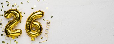 26 numaralı altın folyo balonu. 26 'ncı yazılı doğum günü veya yıldönümü kartı, gri beton arka plan. Yıldönümü kutlaması. Pankart. Boşluğu kopyala