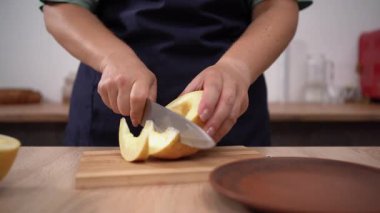 Close-up of Chef cuts apples with knife on a cutting board. Apple diet with vitamins. copy space
