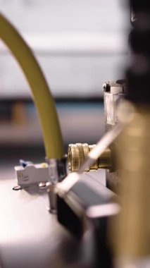 Close-up of vacuum hose coupling and brass fitting connected to washing vacuum machine used for upholstery cleaning. Detail highlights water inlet attachment. vertical video