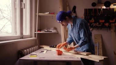 Marangoz atölyedeki matkap ucu için tahta vida seçiyor. Boşluğu kopyala