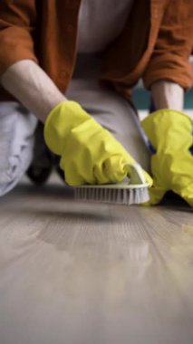 Temizlik görevlisinin kaplama zemini fırçayla ovalamasını kapat. dikey video