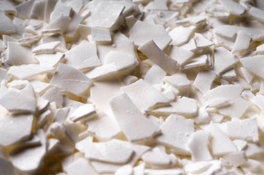 Mum yapımı için beyaz soya gevreğini kapatın. Soya mumu taneciklerinin hafif dokusu. Ev yapımı mumlar için. Ekolojik yaşam tarzı.