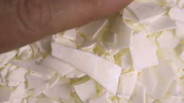 Evde yaratıcı bir hobi. Bir adam malzemeleri karıştırırken soya cilasını topluyor..