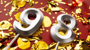Kırmızı şenlik programında konfeti geçmişi olan 98 numaralı doğum günü rakamı. 98 'inci yaş günü. Doğum günü, yıldönümü ve tarih kavramı. Boşluğu kopyala