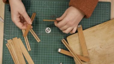Creative hobby of homemade candle making. Woman using wooden wicks at home workshop. concept of making candles