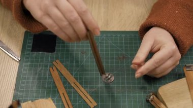 Creative hobby of homemade candle making. Woman using wooden wicks at home workshop. concept of making candles
