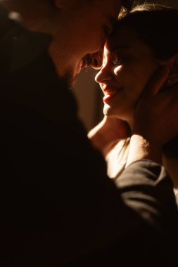 couple on dark background. Sensual portrait of family embracing while dating. Lovers couple spends time together. close-up