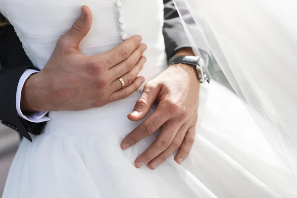 Bridegroom embraces his bride — Stock Photo, Image