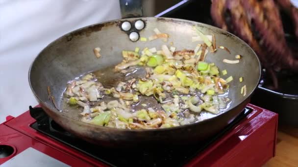 厨师烹调八爪鱼的法式 将视野闭合成平底锅与油炸洋葱片加整个八爪鱼 食肆美味佳肴配制概念 — 图库视频影像