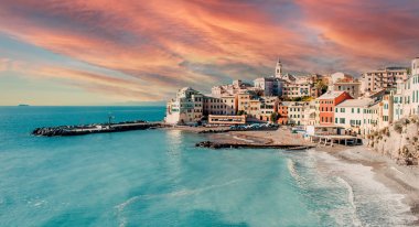 View of Bogliasco during colorful bright cloudy pink sky sunset. Bogliasco is ancient fishing village in Italy. Europe clipart