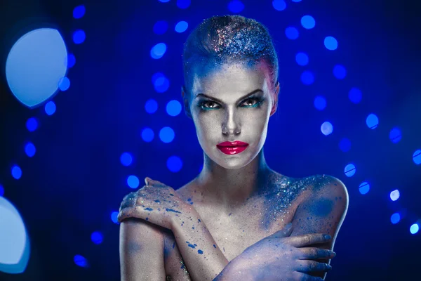 Beautiful woman with creative bright make-up over glowing lights — Stock Photo, Image