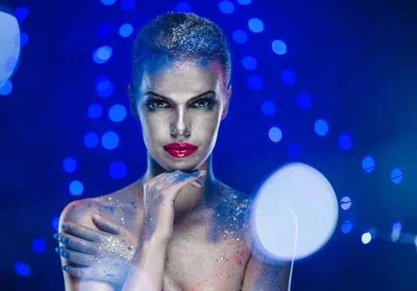 Beautiful woman with creative bright make-up over glowing lights — Stock Photo, Image