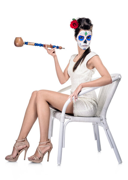Day of the dead girl with sugar skull make-up isolated on white
