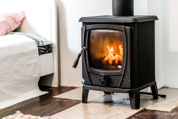 Wood burning stove in bedroom — Stock Photo, Image