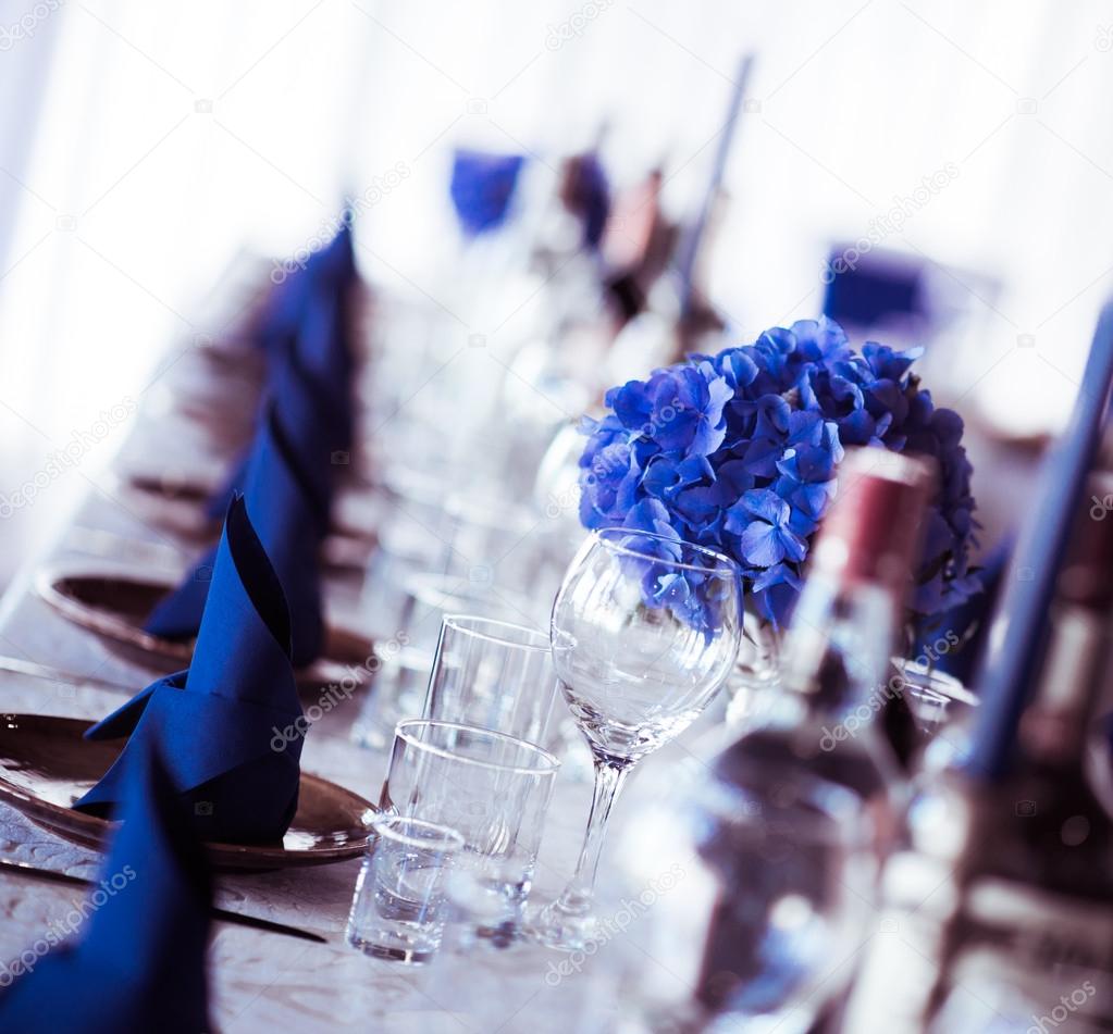 Wedding table. Close-up of folded napkin and empty glasses 