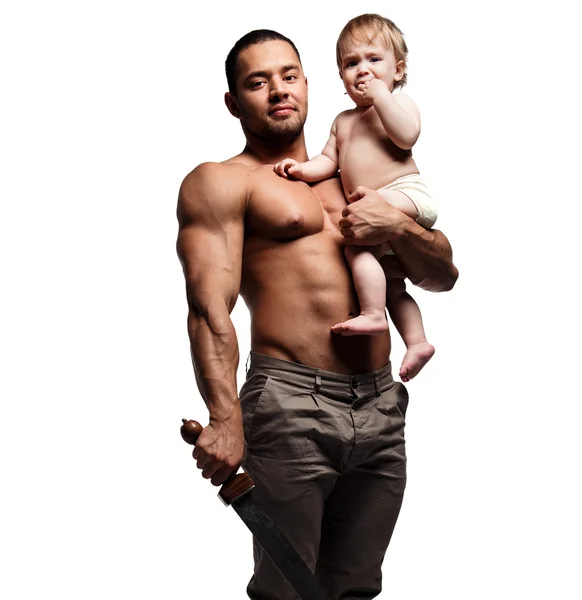 Father hugging a baby and holding a sword — Stock Photo, Image