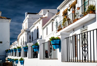 Typical spanish white village houses with flower pots.  clipart