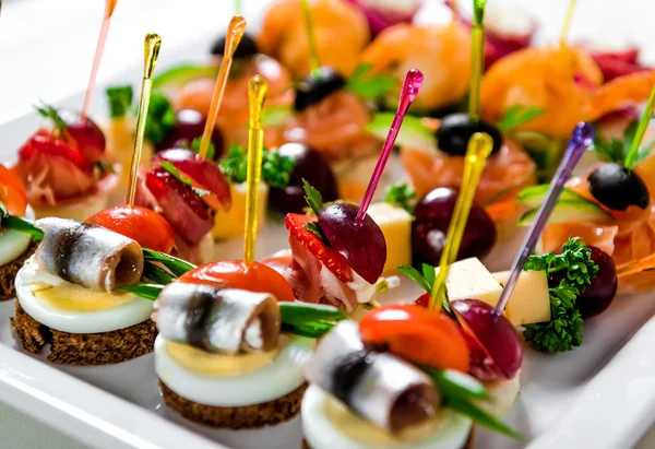 Plate with various seafood and meat canapes — Zdjęcie stockowe
