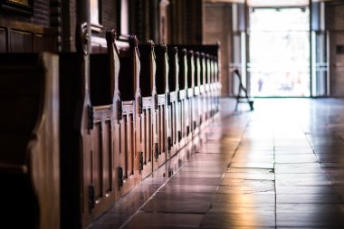 Wooden pews in a row in a church clipart