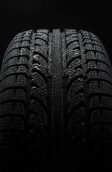 Tire with water drops over black background — Stock Photo, Image