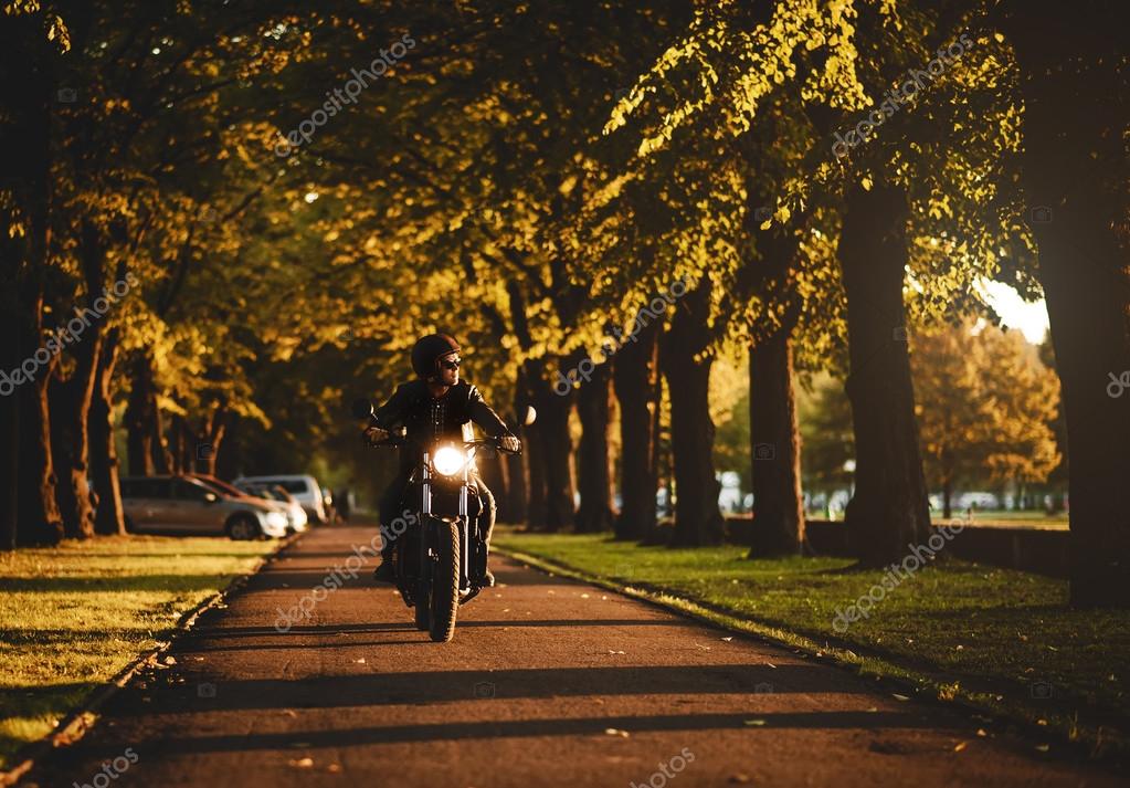 Man riding a cafe-racer motorcycle outdoors — Stock Photo © amoklv ...