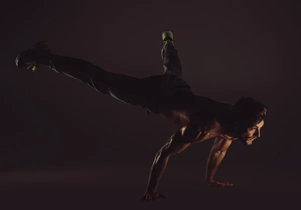 Young sportive man doing yoga exercises, studio shot — Stock Photo, Image