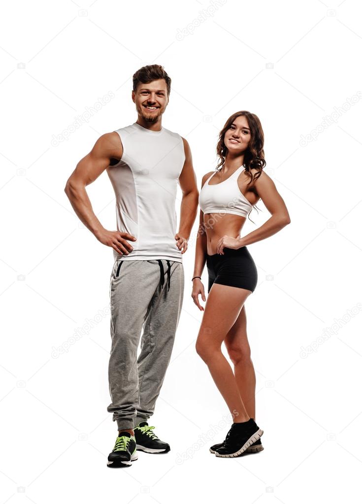 Young and beautiful athletic woman and man isolated on white background