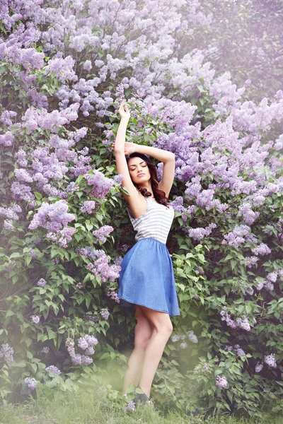 Woman near a lilac bush,tinted — Stock Photo, Image