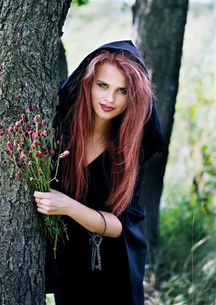 Witch gathers herbs — Stock Photo, Image