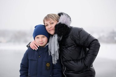 Kışın anne ve oğlunun sıradan portresi.