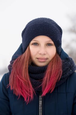 Pembe saçlı, şapka takan kız.