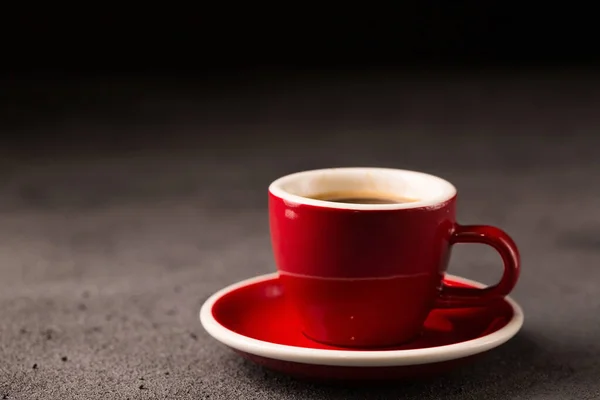 Black brewed coffee in a red coffee cup