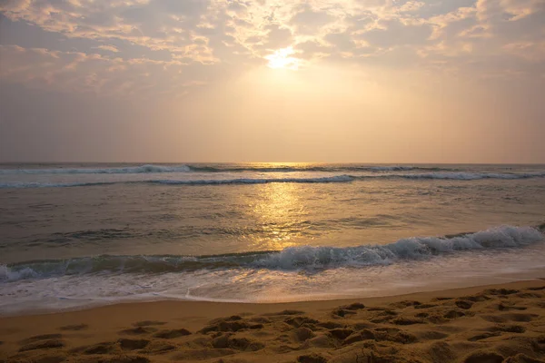 Beautiful pink sunset by the raging ocean, summer background