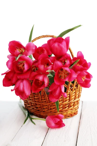 Pink tulips in a wicker basket — Stock Photo, Image